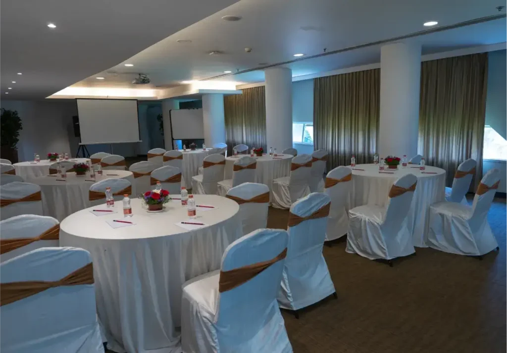 A banquet hall at Galaxy Club, Malleswaram, set with round tables